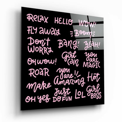 Black glass wall art panel displaying pink handwritten-style text with motivational phrases including "Relax," "Girl Boss," and "You are Magic," shown at a three-quarter angle.