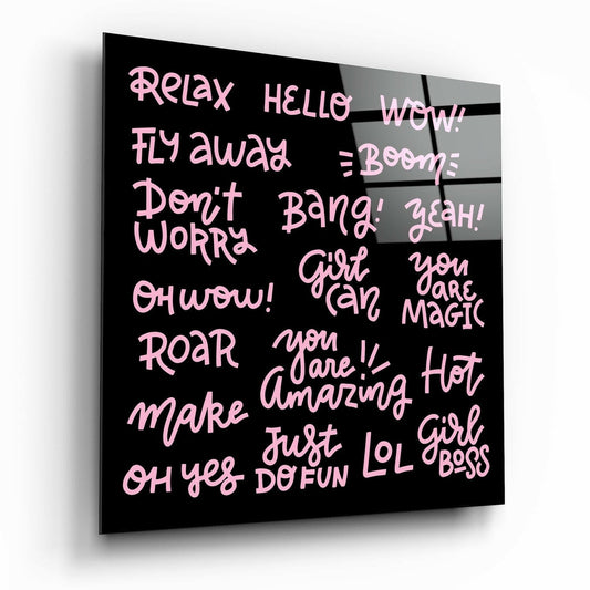 Black glass wall art panel displaying pink handwritten-style text with motivational phrases including "Relax," "Girl Boss," and "You are Magic," shown at a three-quarter angle.