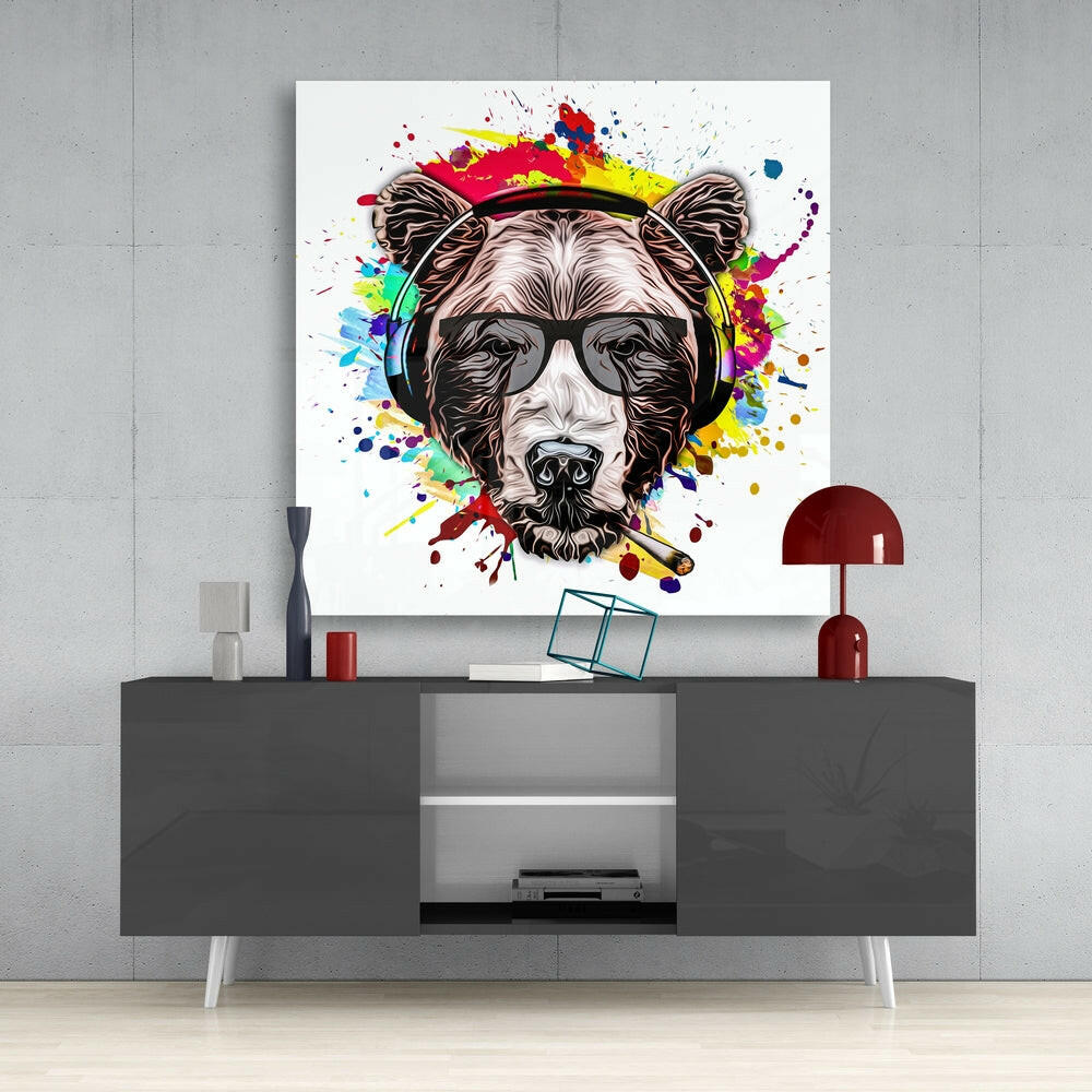 Colorful pop art bear head with sunglasses and headphones displayed above gray media console in modern interior setting.