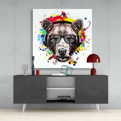 Colorful pop art bear head with sunglasses and headphones displayed above gray media console in modern interior setting.