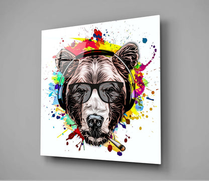 Glass wall art featuring an illustrated bear wearing headphones and sunglasses surrounded by colorful paint splatters on white background.