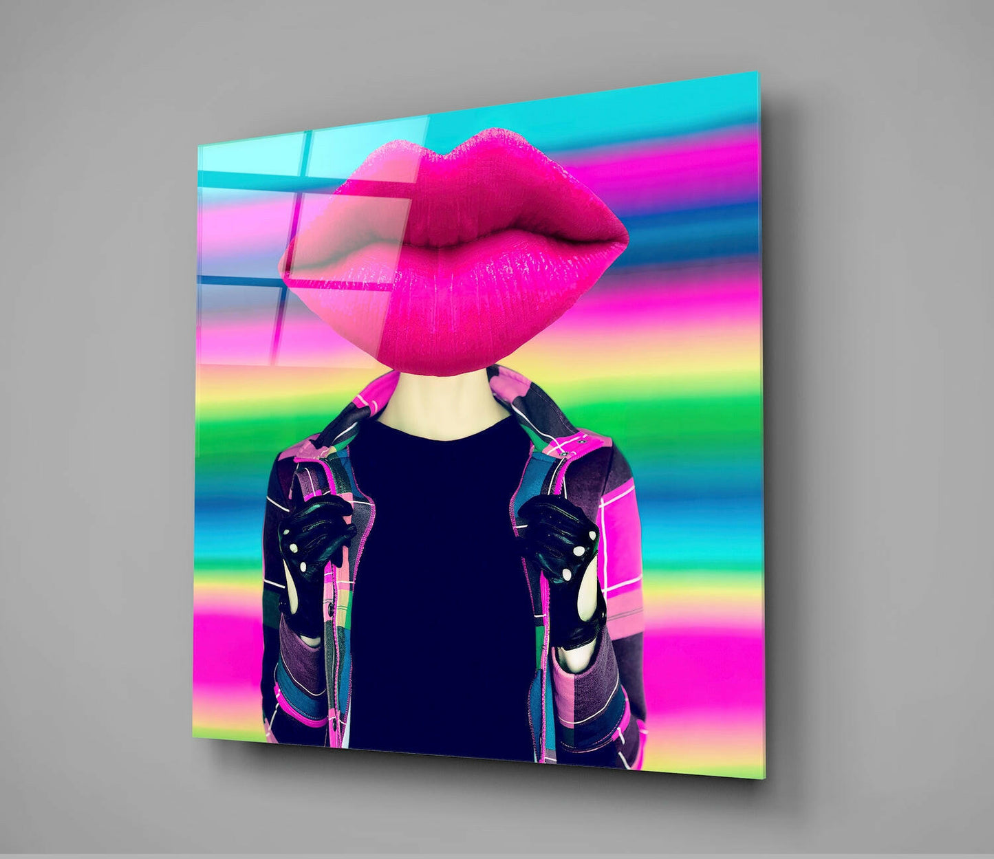 Glass wall art displaying surreal figure with oversized magenta lips against rainbow gradient background, wearing geometric patterned jacket.