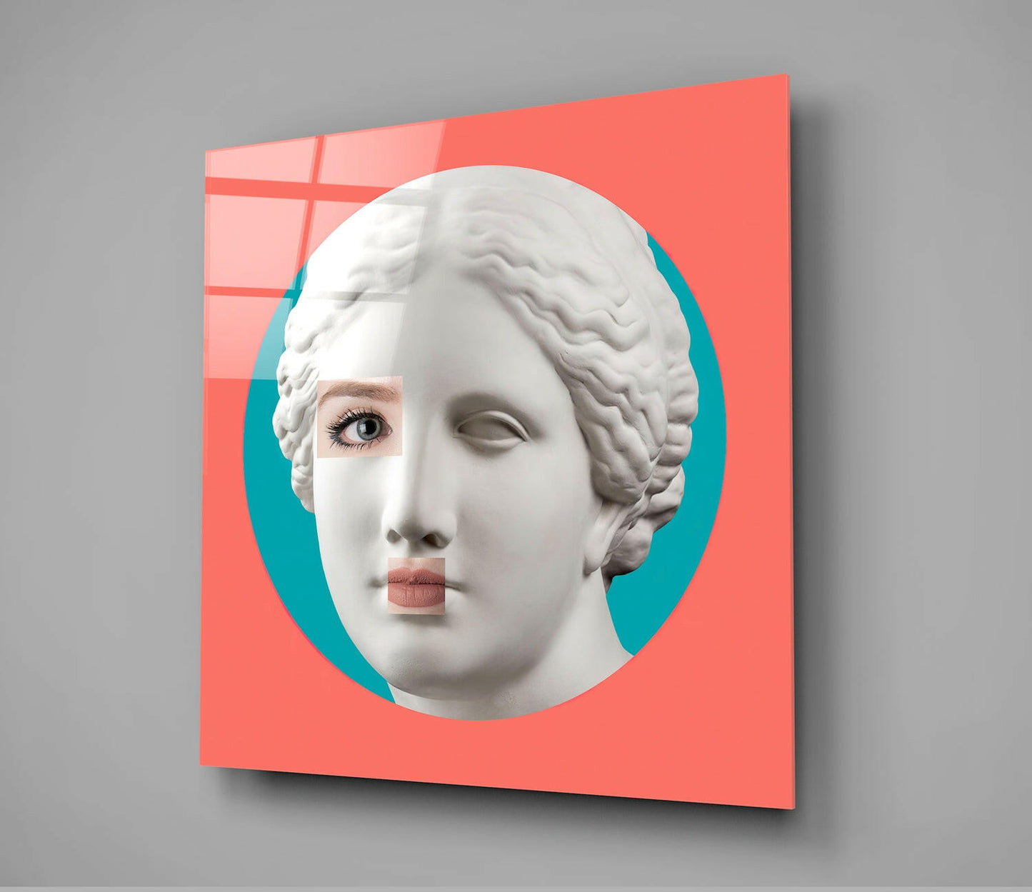 Modern pop art glass wall panel featuring a classical white plaster bust with realistic human eyes and lips against a coral red and turquoise background.