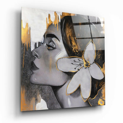 Angled side view of glass wall art depicting a woman's profile with gold leaf accents and a white flower, displayed against white background.