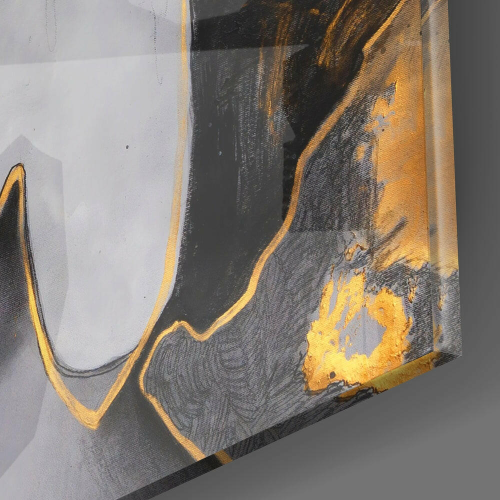 Close-up angled view of black glass with gold and yellow brushstroke accents and dripped details against white background.