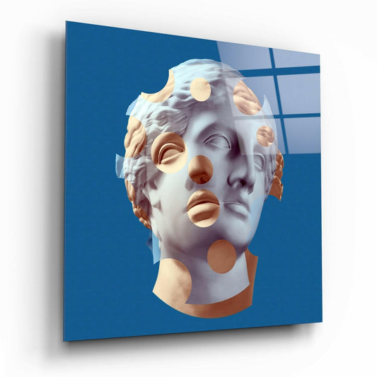 Classical white plaster bust with gold and bronze circular cutouts on blue gridded background, displayed at an angle.