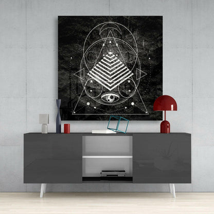 Black and white geometric sacred geometry canvas art displayed above a gray media console with red accents in a modern interior setting.