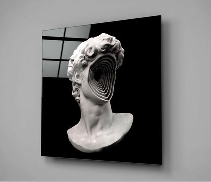 White plaster classical bust with concentric circular void through face, displayed on black background glass panel.