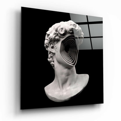 White plaster classical bust with concentric black spiral cutout through the head, displayed against dark background with grid pattern.