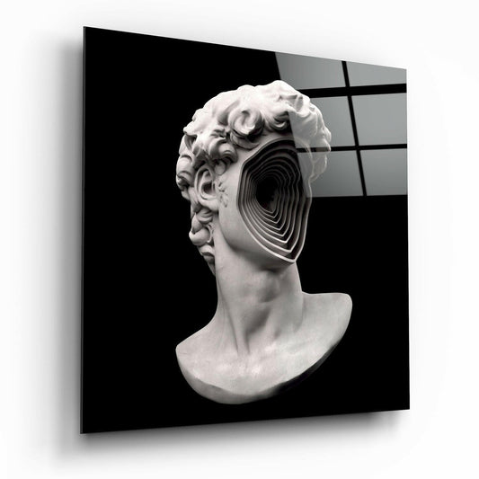 White plaster classical bust with concentric black spiral cutout through the head, displayed against dark background with grid pattern.