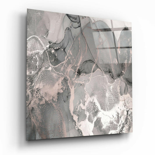 Rose gold and gray marble glass wall art panel displayed at an angle, showing swirling abstract patterns in cream, gray, and metallic tones.