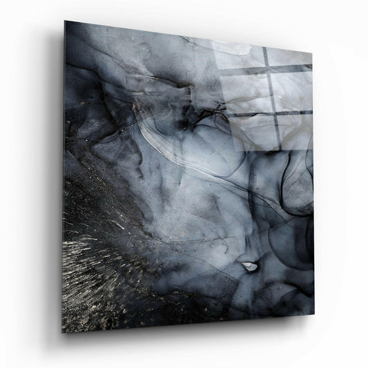 Abstract swirling black and gray ink patterns with metallic gold accents on translucent glass, angled perspective showing dimensional depth.