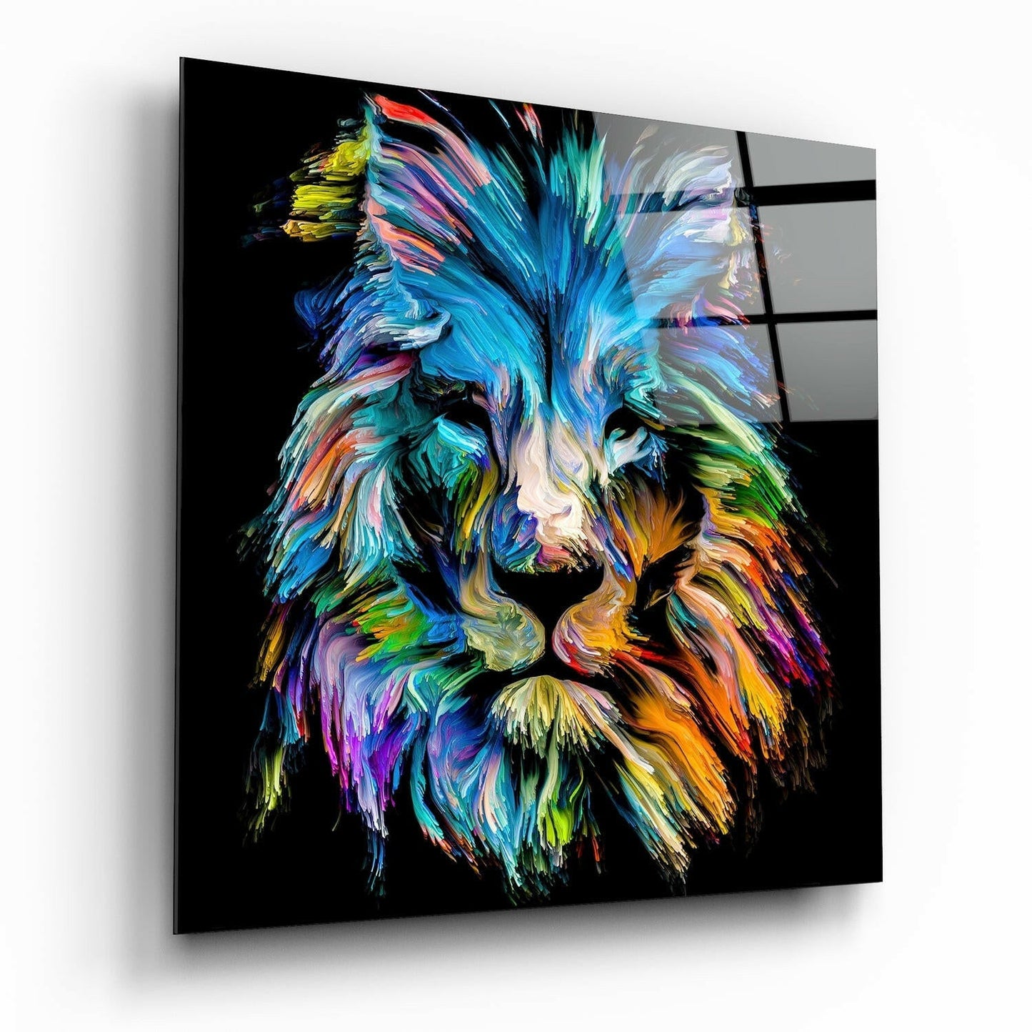 Colorful abstract lion head with vibrant blue, cyan, orange, and yellow brushstrokes on black glass panel, displayed at angle.