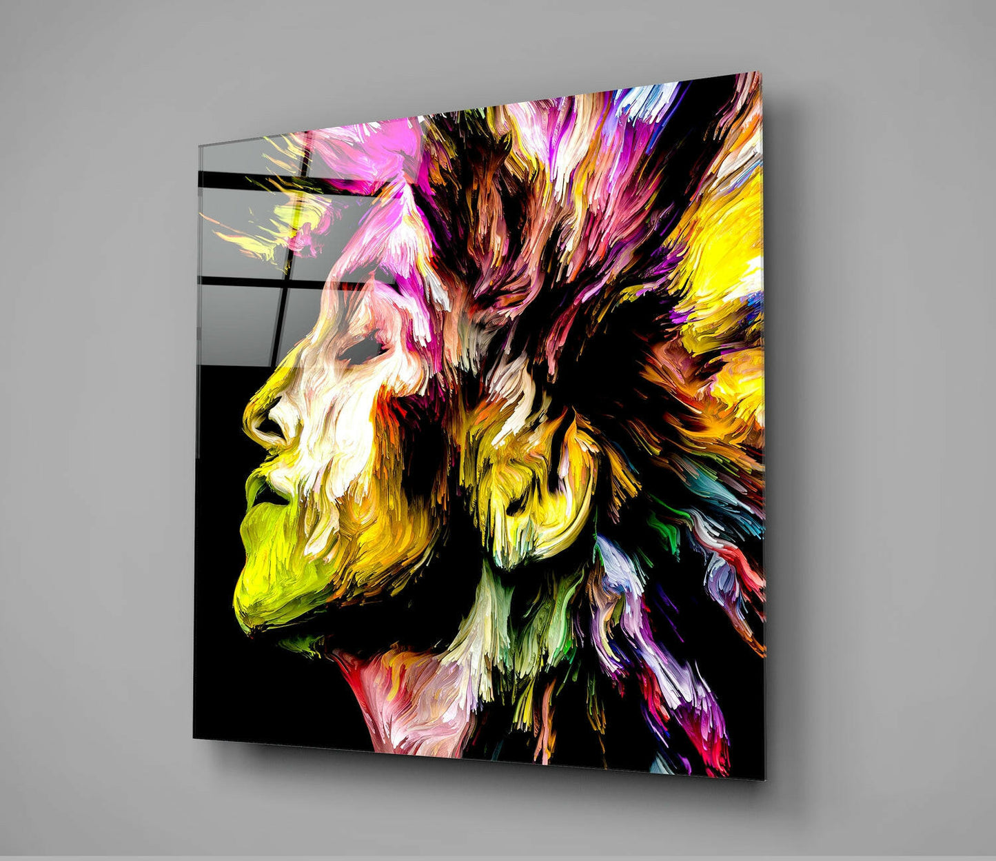 Colorful abstract portrait of a bearded man's profile in vibrant paint strokes on black glass wall art, angled perspective.