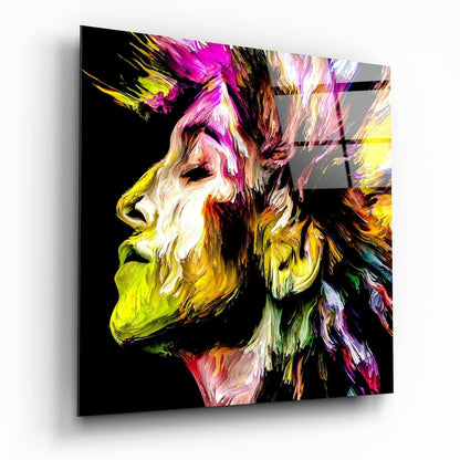 Colorful abstract portrait of a bearded man in profile with vibrant brushstroke effects in magenta, yellow, and green on black glass panel.