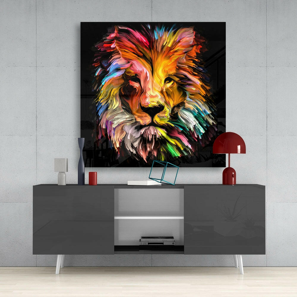 Colorful abstract lion head glass wall art with rainbow hues displayed above gray media console in modern interior setting.