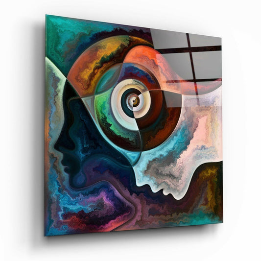 Abstract glass wall art featuring a swirled eye design with marbled teal, orange, red, and purple tones, displayed at an angled perspective.