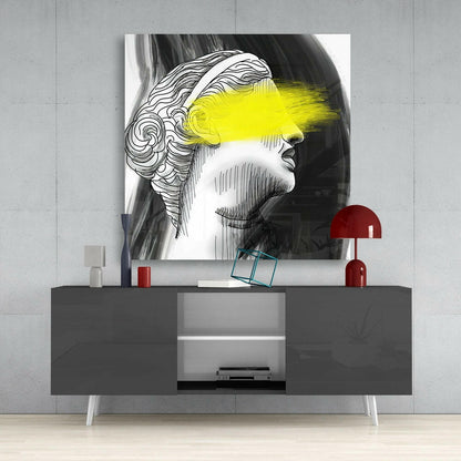 Black and white line-drawn portrait with bright yellow eye bar displayed above gray media console with red lamp and accessories.