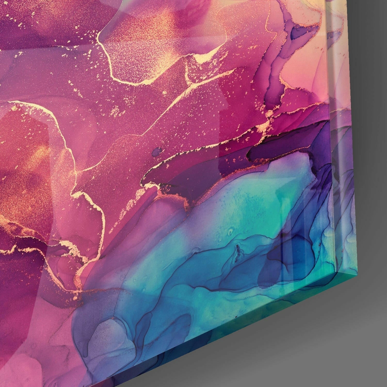 Close-up angled view of glass art with pink, magenta, and turquoise gradient layers and gold accents.