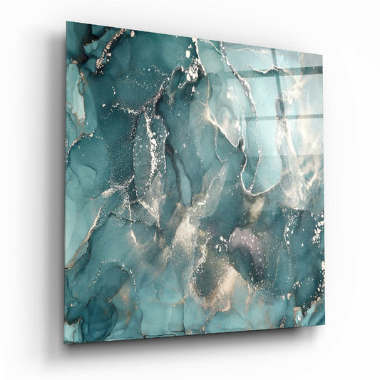 Angled perspective view of teal and cream marbled glass wall art with white metallic accents and fluid swirling patterns.