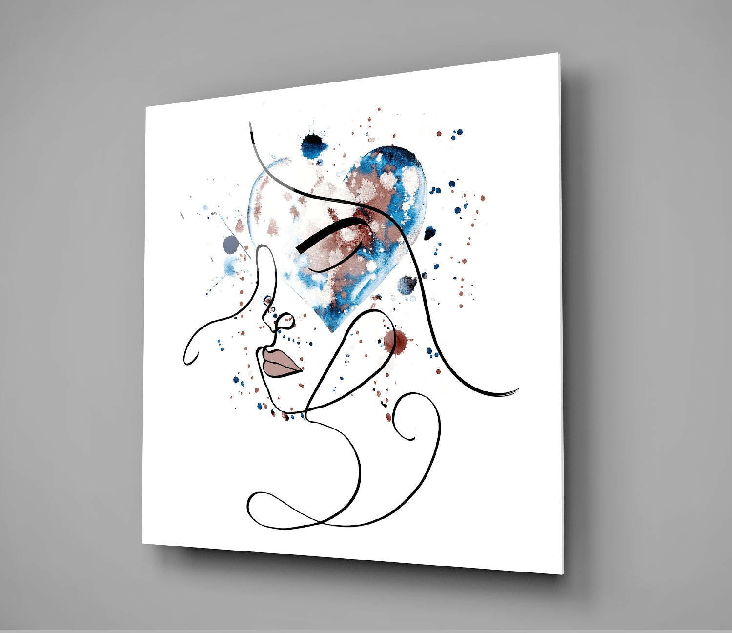 Modern line art glass wall art displaying an abstract face profile with watercolor blue and brown splashes against white background, mounted at angle.