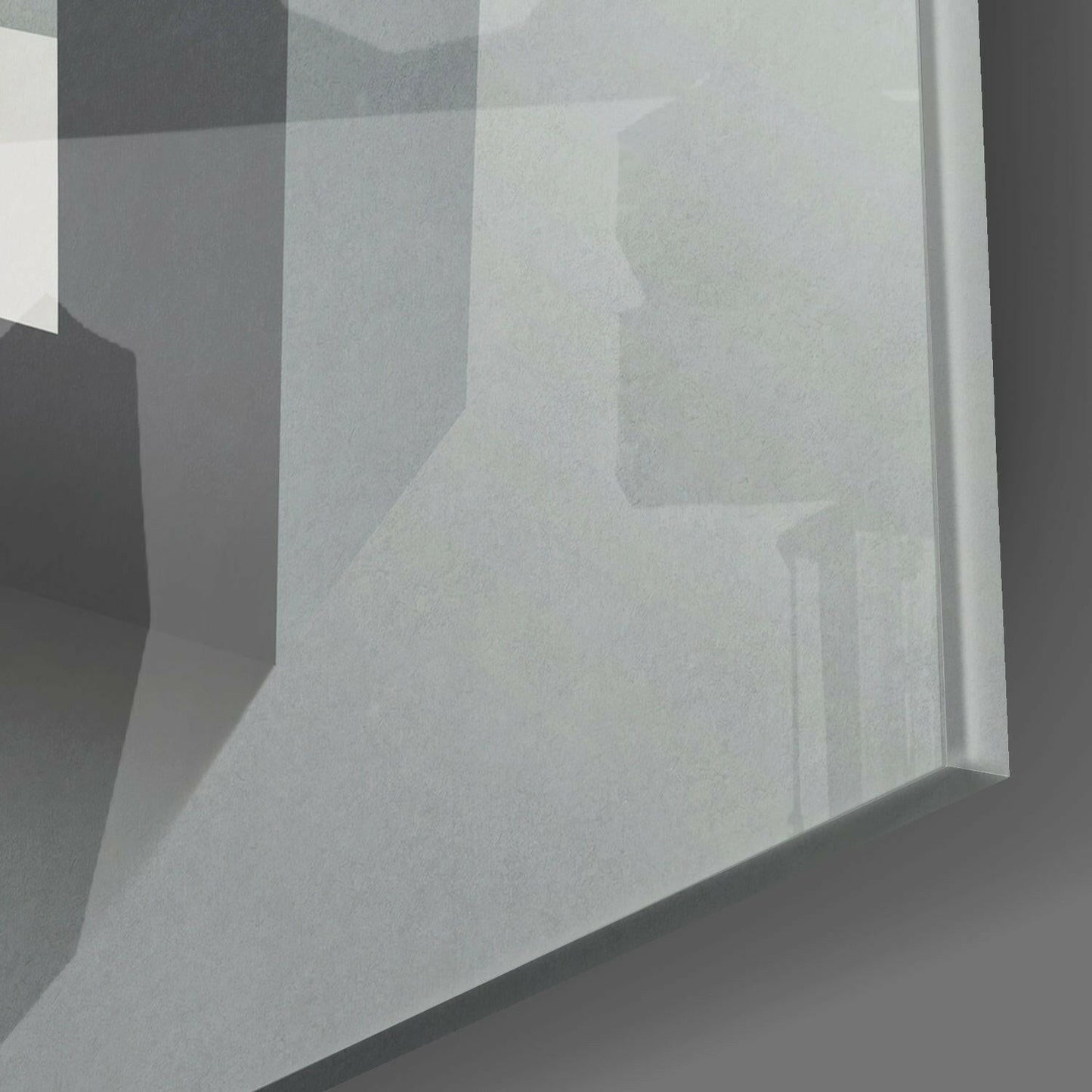 Close-up angled view of frosted glass panel with layered geometric shapes in grayscale tones, showing depth and shadow effects.