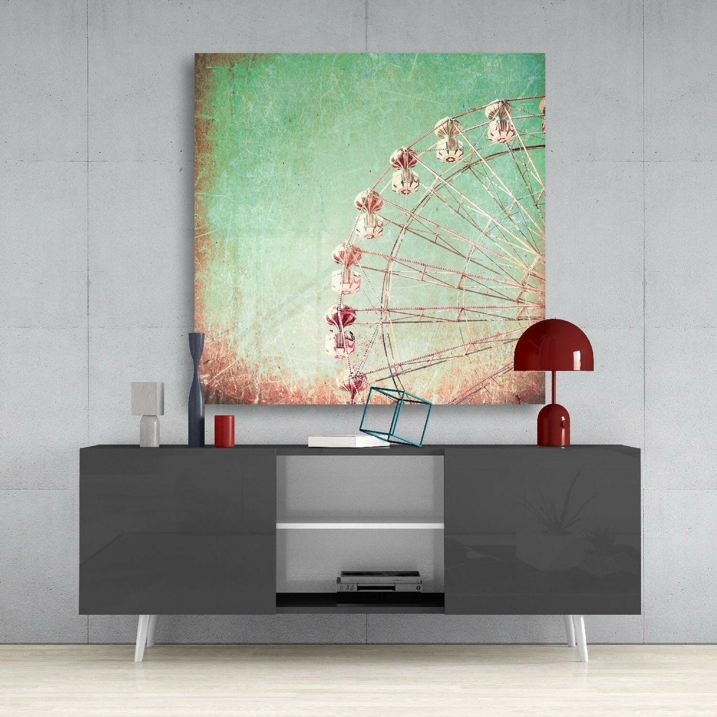 Ferris wheel canvas art with mint-to-coral gradient displayed above gray media console with red lamp and accessories.