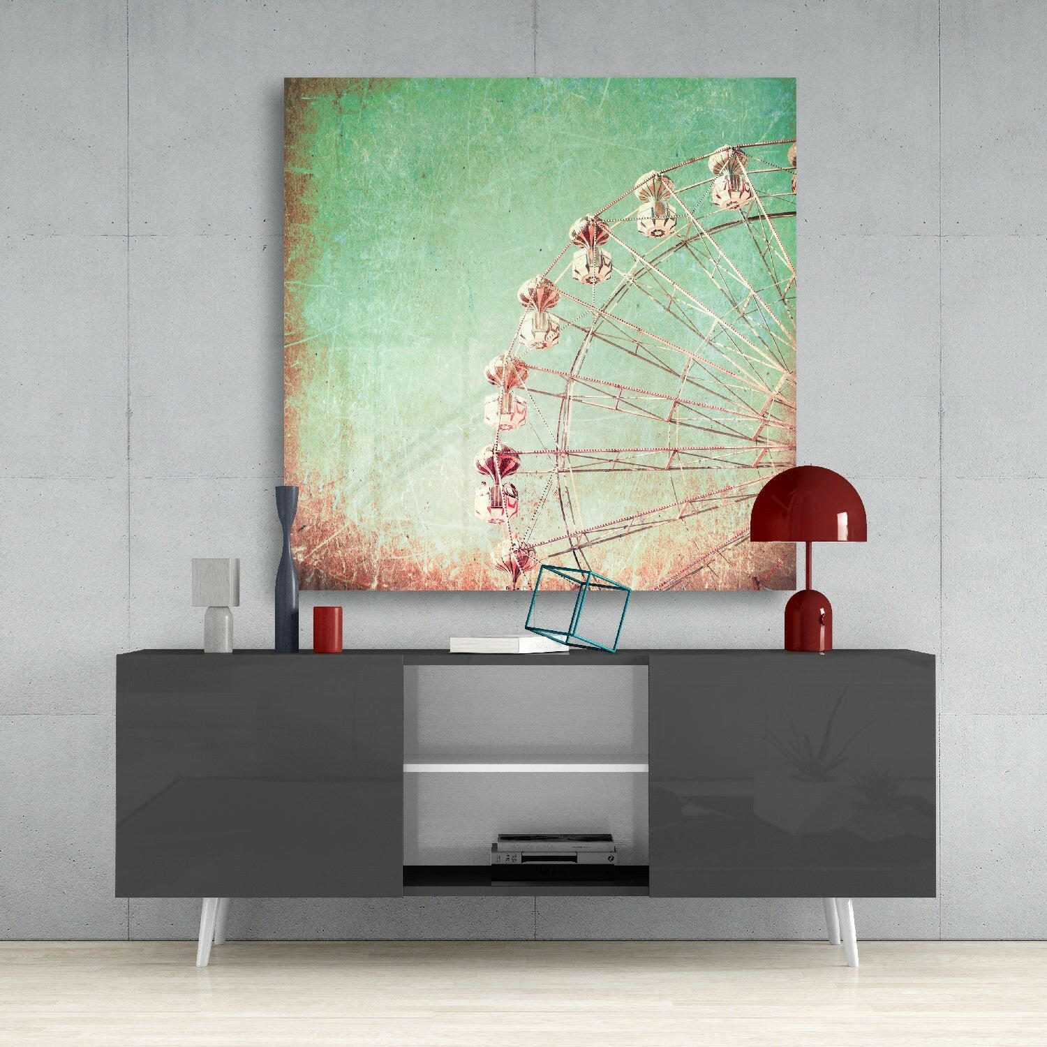 Ferris wheel canvas art with mint-to-coral gradient displayed above gray media console with red lamp and accessories.