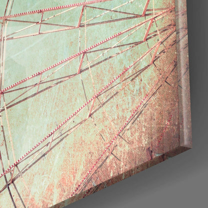 Close-up edge view of glass wall art showing layered mint green and rust-toned glass with red rivets and metal framework details.