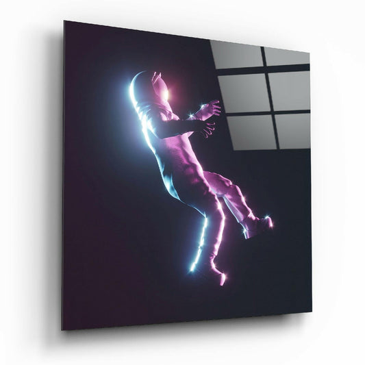 Angled view of glass wall art displaying a neon-outlined figure in cyan and magenta diving pose against dark background.