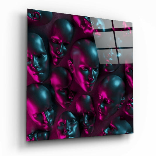 Angled perspective view of glass wall art displaying multiple metallic black and teal faces illuminated by vibrant magenta lighting against a dark background.