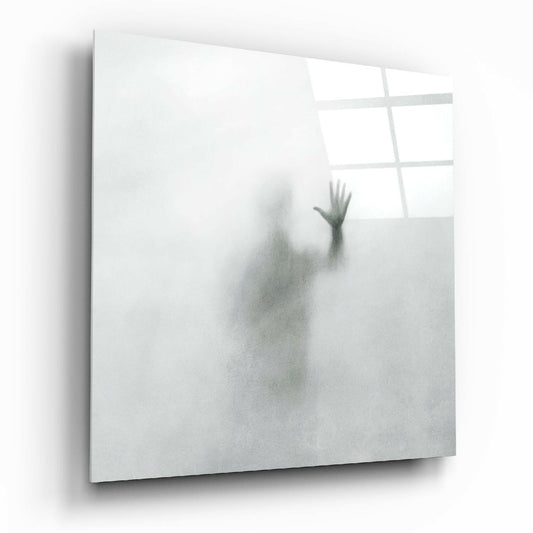 Angled view of a frosted glass panel displaying a blurred silhouette of a raised hand against a misty background, with window panes visible above.