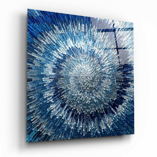 Blue glass wall art panel displaying radial striped pattern in shades of white, light blue, and dark blue, photographed at an angle against white background.