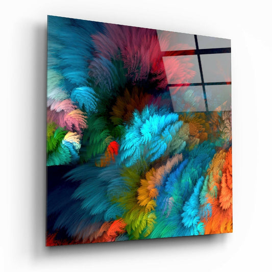 Angled perspective view of colorful feather burst glass wall art with teal, maroon, orange, and green swirling patterns behind a dark grid overlay.