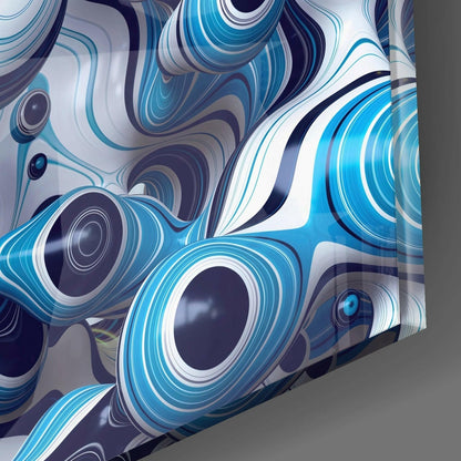 Close-up angled view of blue and white glass wall art with concentric circular patterns and swirling designs in navy, cyan, and white tones.