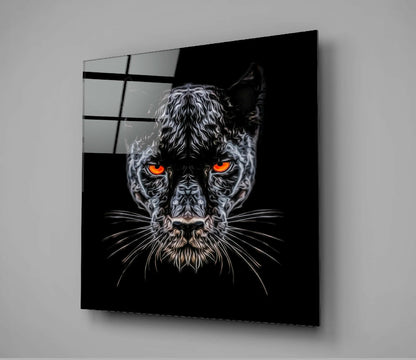 Black glass wall art displaying a stylized panther head with glowing orange eyes and white fur detail against dark background.