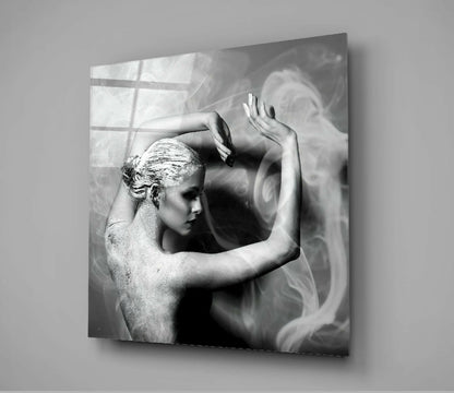 Black and white glass wall art showing a shirtless figure in profile with raised arms against smoky, swirling background patterns.