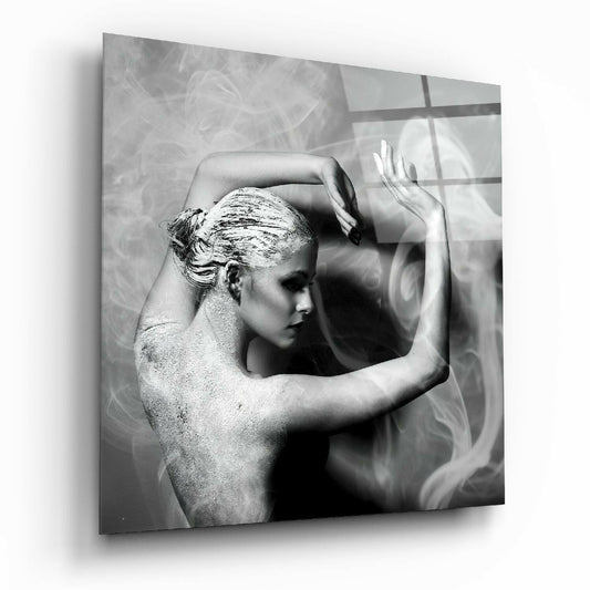 Black and white glass wall art depicting a shirtless figure in profile with gold leaf on hair, hands raised, against textured background with window shadows.