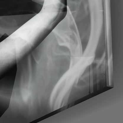 Close-up detail of translucent glass wall art showing swirling smoke-like patterns in monochromatic gray and white tones.