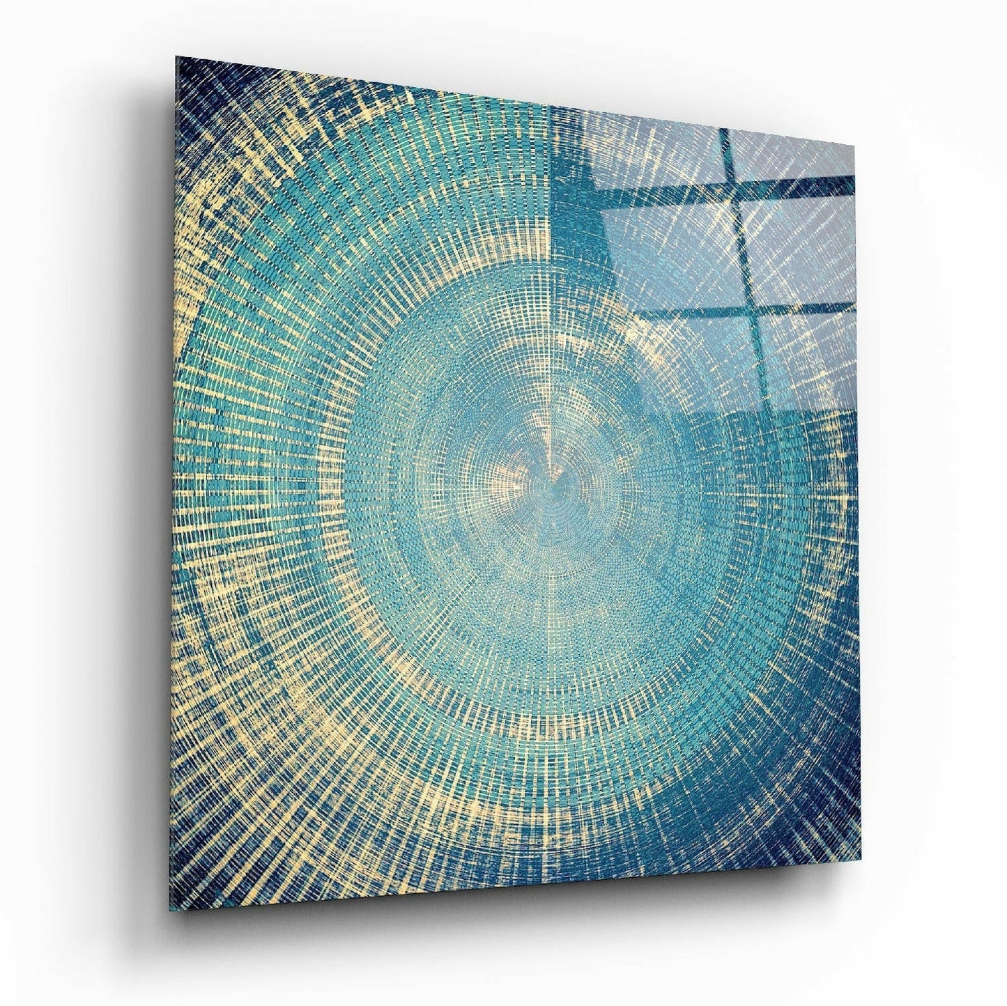 Square glass panel with concentric circular pattern in teal, cream, and navy blue, displayed at an angle showing depth and shadow.