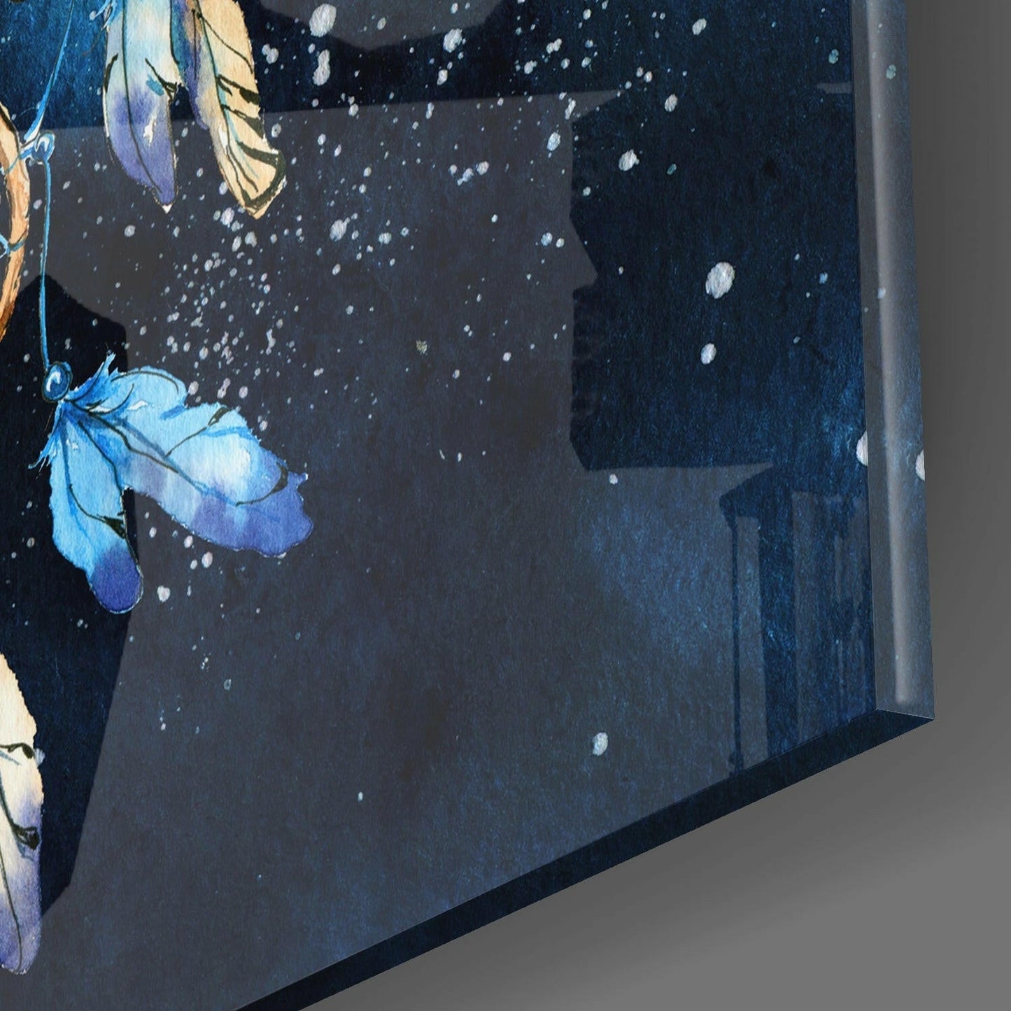 Close-up angled view of dark glass wall art featuring blue and yellow flowers with white sparkle details against a starry night background.