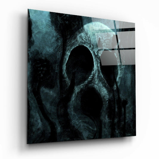 Angled view of teal and black glass wall art featuring a textured skull design with hollow eye sockets and horizontal stripe overlay.