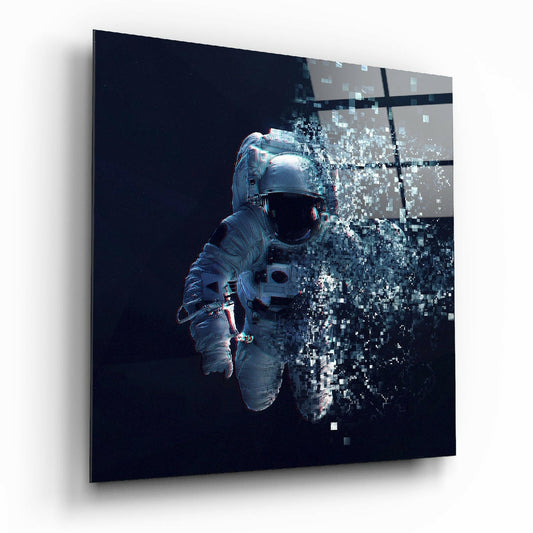 Angled view of a glass wall art panel showing an astronaut in a spacesuit against black background with pixelated digital dispersion effect on the right side.