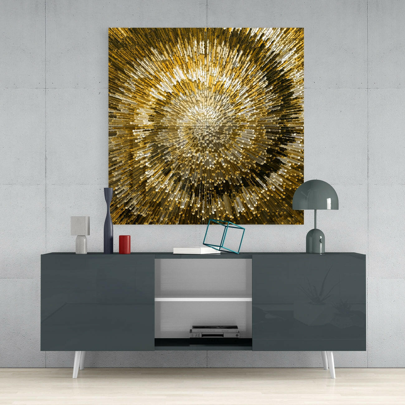 Gold and white radiating glass wall art hung above a dark gray media console with white legs and decorative accessories.
