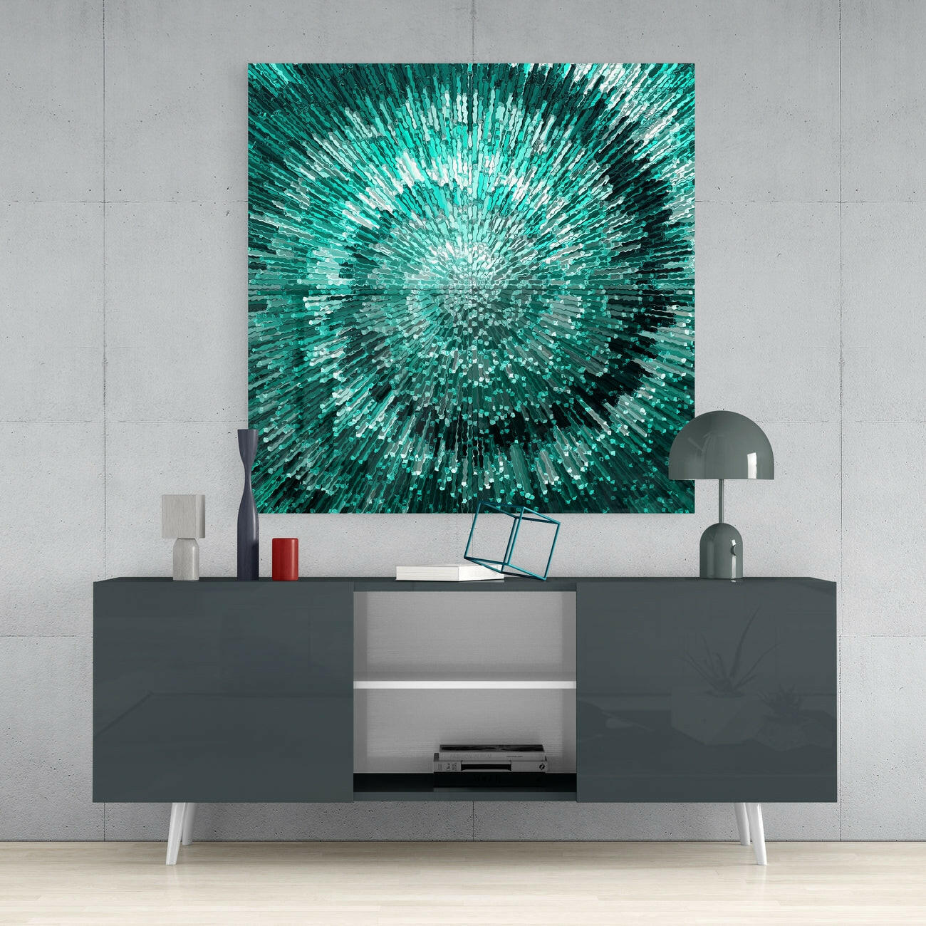 Teal and white radial glass wall art hung above a dark media console with white legs in a minimalist interior setting.