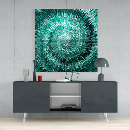 Teal and white radial glass wall art hung above a dark media console with white legs in a minimalist interior setting.