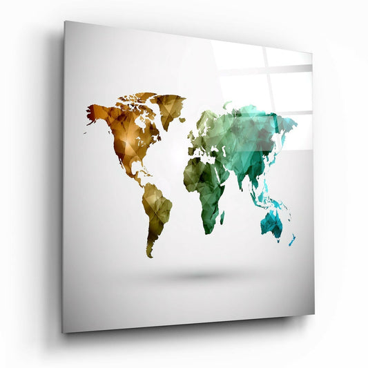 Angled perspective of glass wall art displaying a low-poly world map in warm gold tones on the left and cool teal-green tones on the right, mounted on white wall.