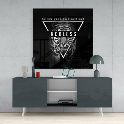 Black and white tiger glass wall art with "RCKLESS" text displayed above modern gray console table in minimalist interior setting.