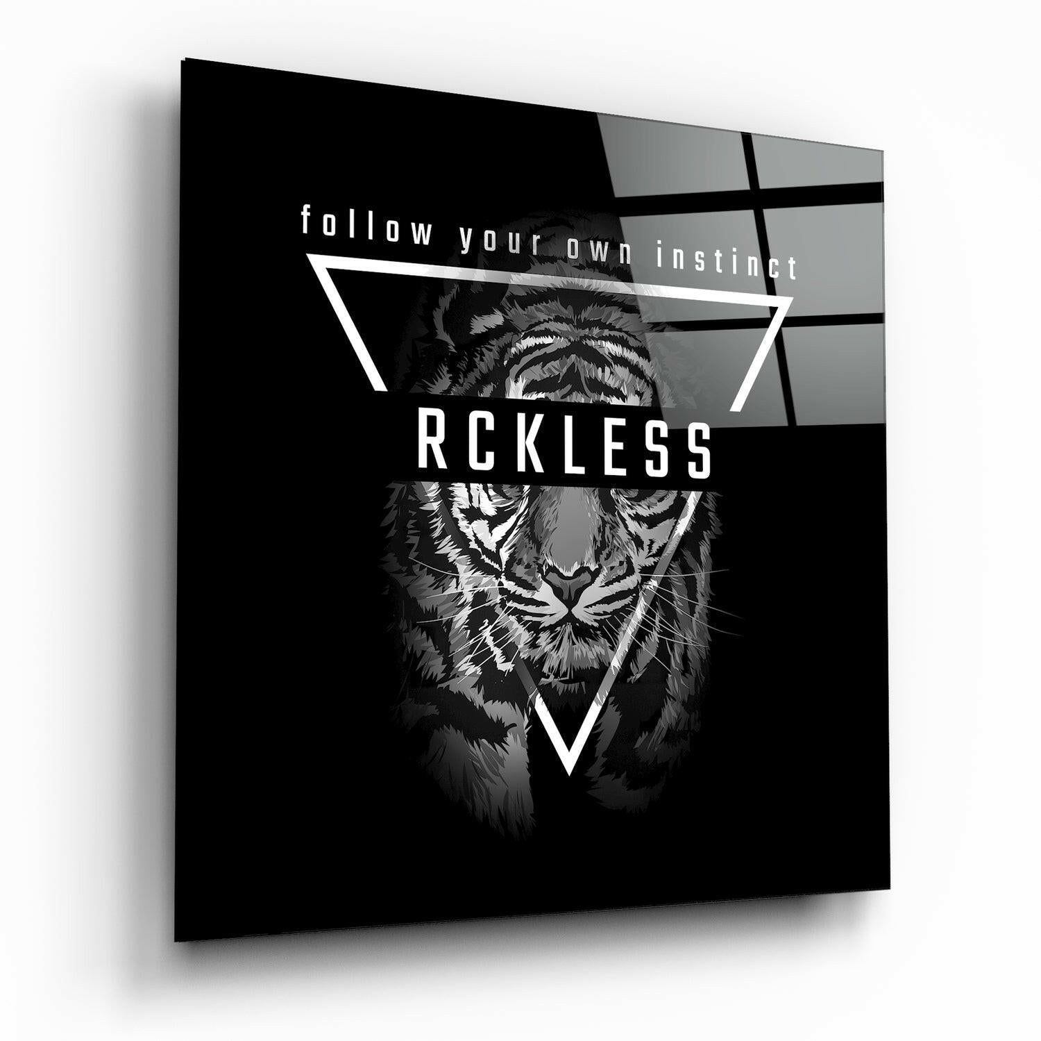 Angled perspective of black glass wall art featuring a tiger illustration with geometric lines and "RCKLESS" text overlaid.