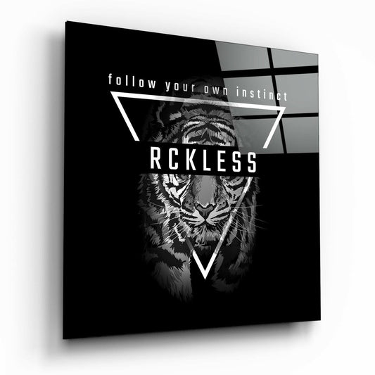 Angled perspective of black glass wall art featuring a tiger illustration with geometric lines and "RCKLESS" text overlaid.